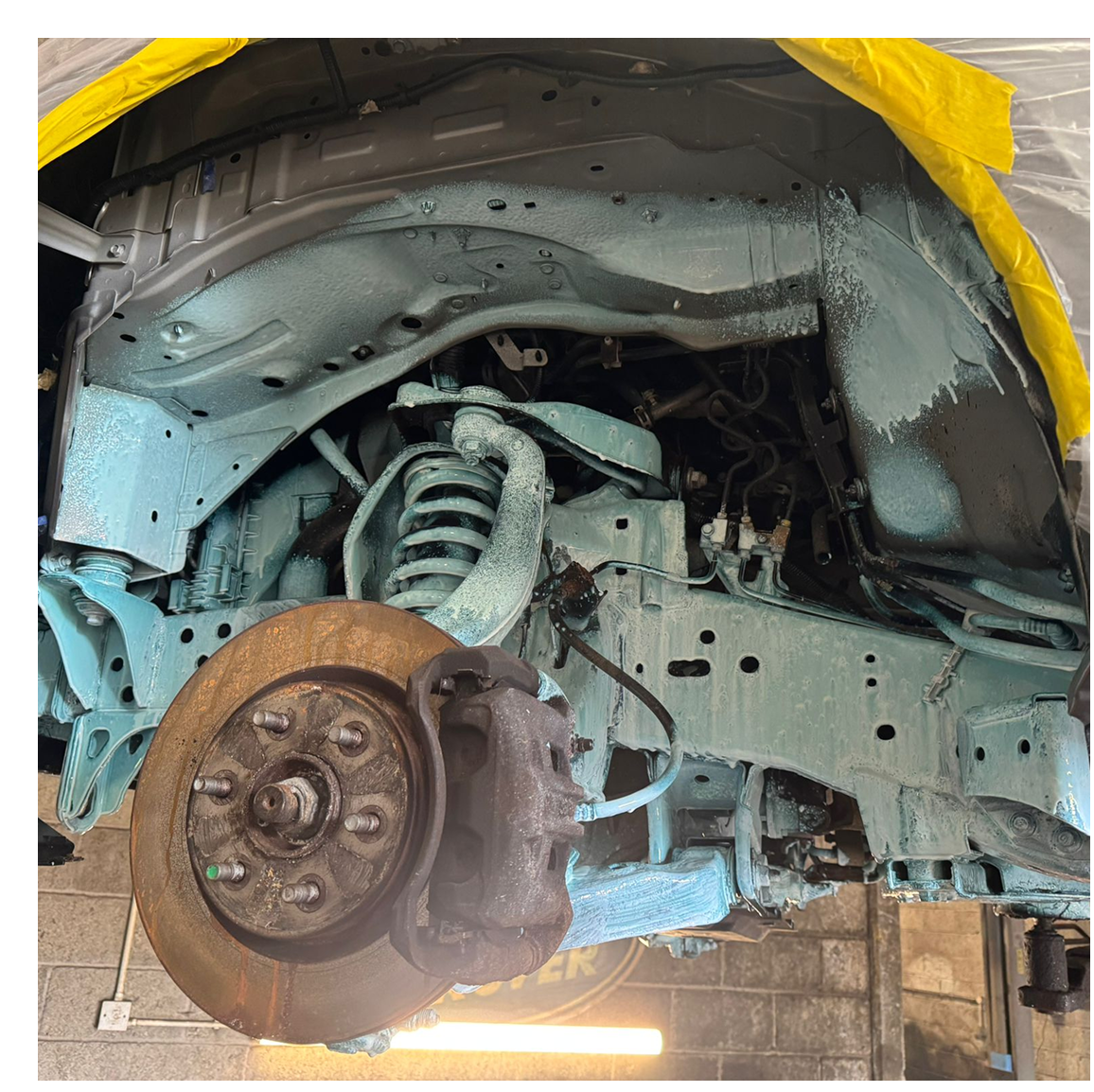Car wheel well with turquoise undercoating