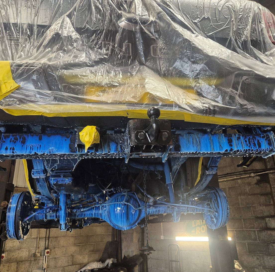 Vehicle underside with tow hitch painted blue